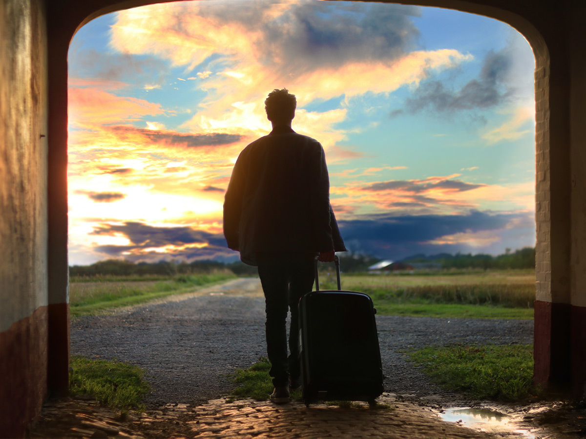 Man with suitcase leaving the building