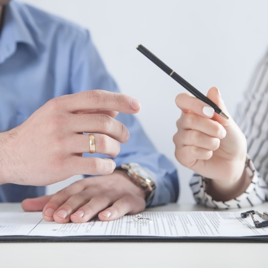 divorced couple signing paperwork