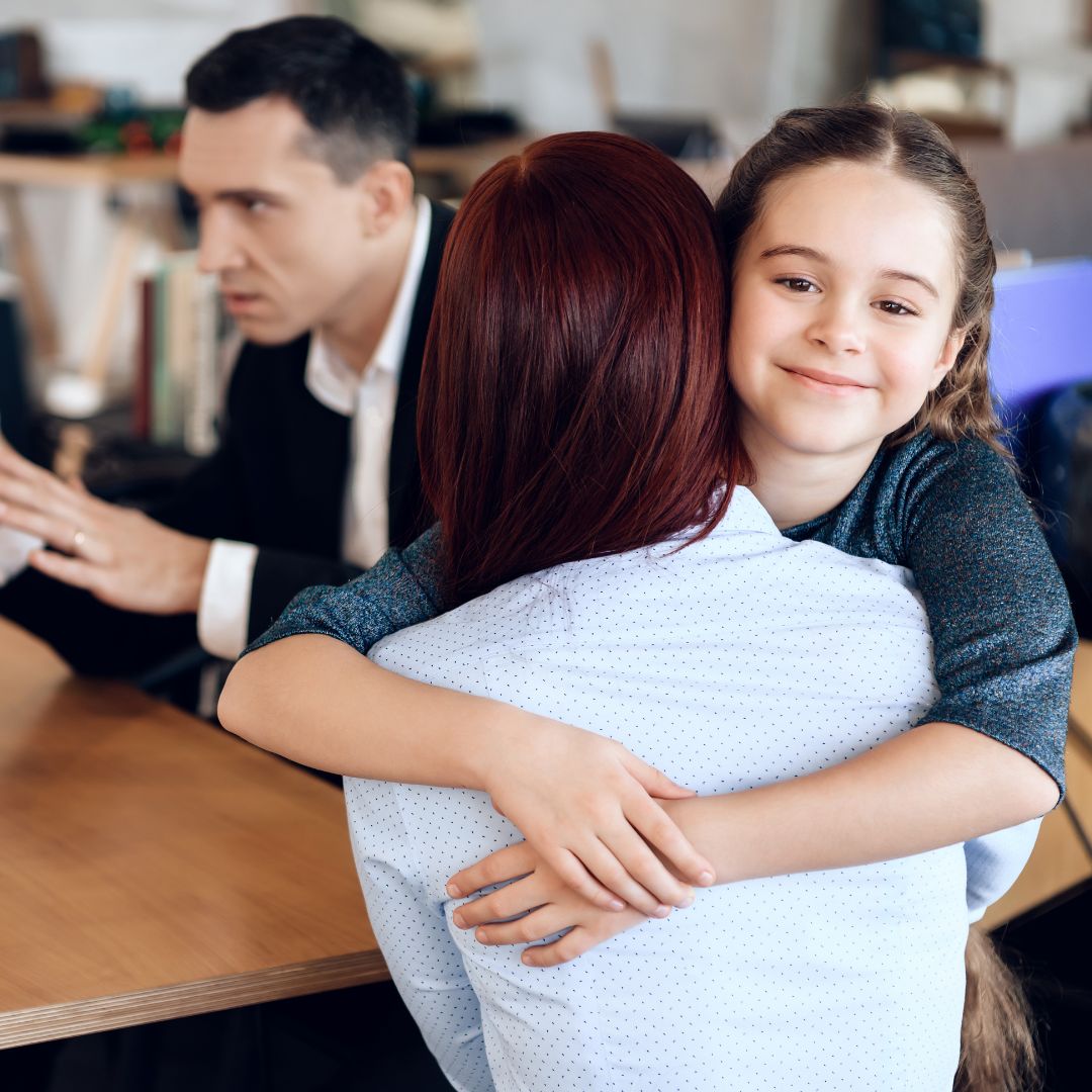 child hugging parent during mediation