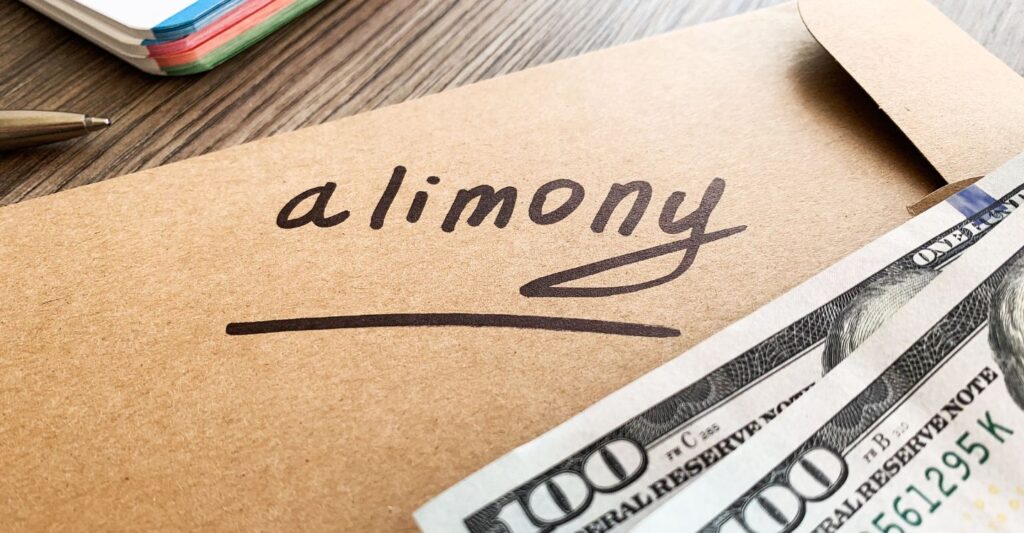 a folder that says alimony with money on top of the folder