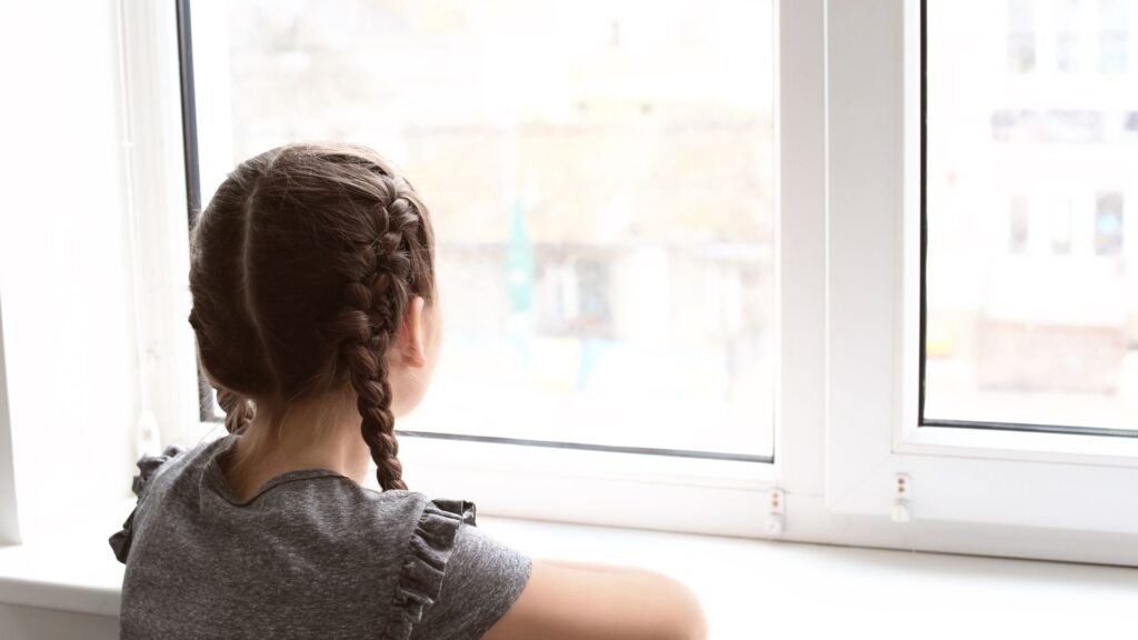 child looking out of window