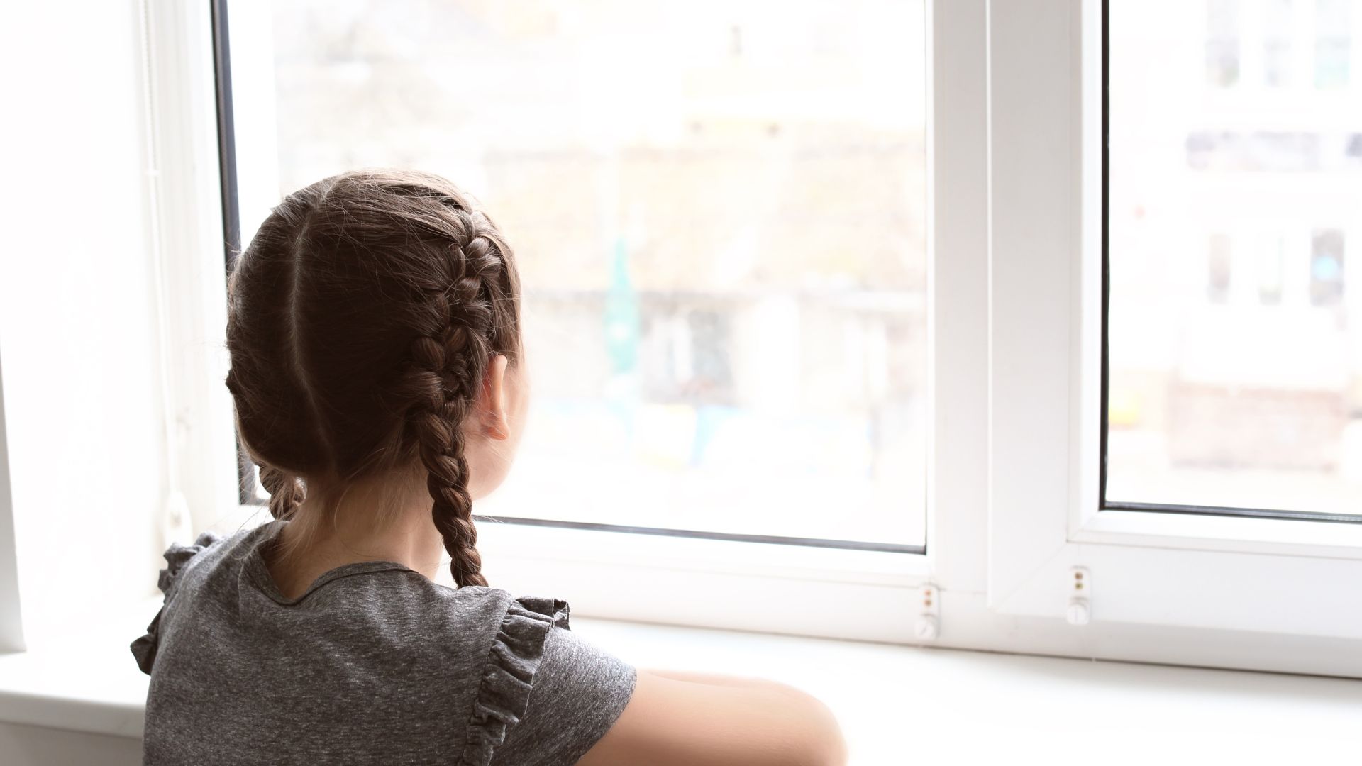 child looking out of window