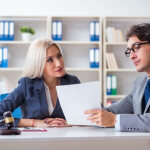 a lawyer and mediator looking over paperwork and talking