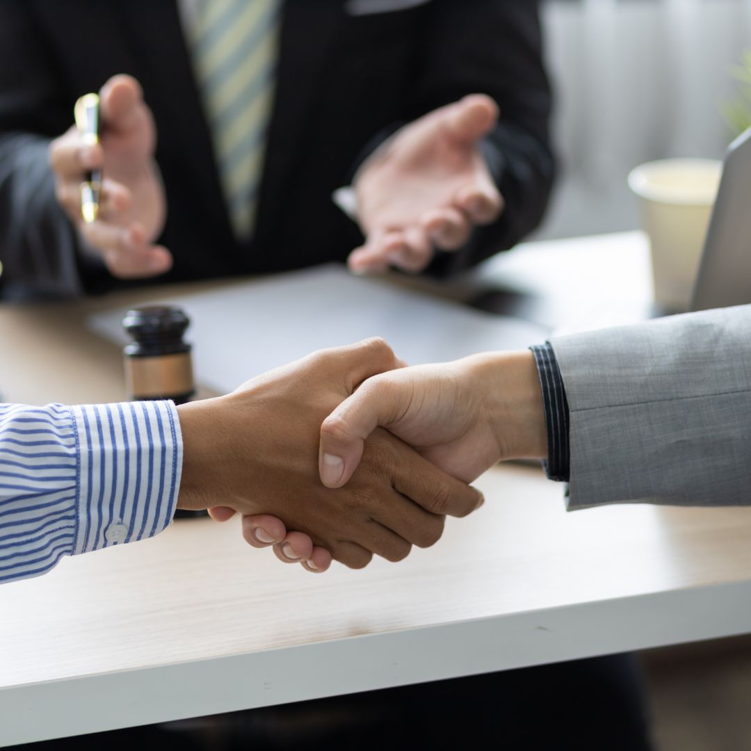 Ex-spouses shaking hands in agreement