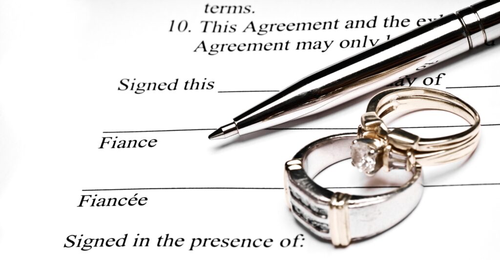 Pen and rings on a prenuptial agreement