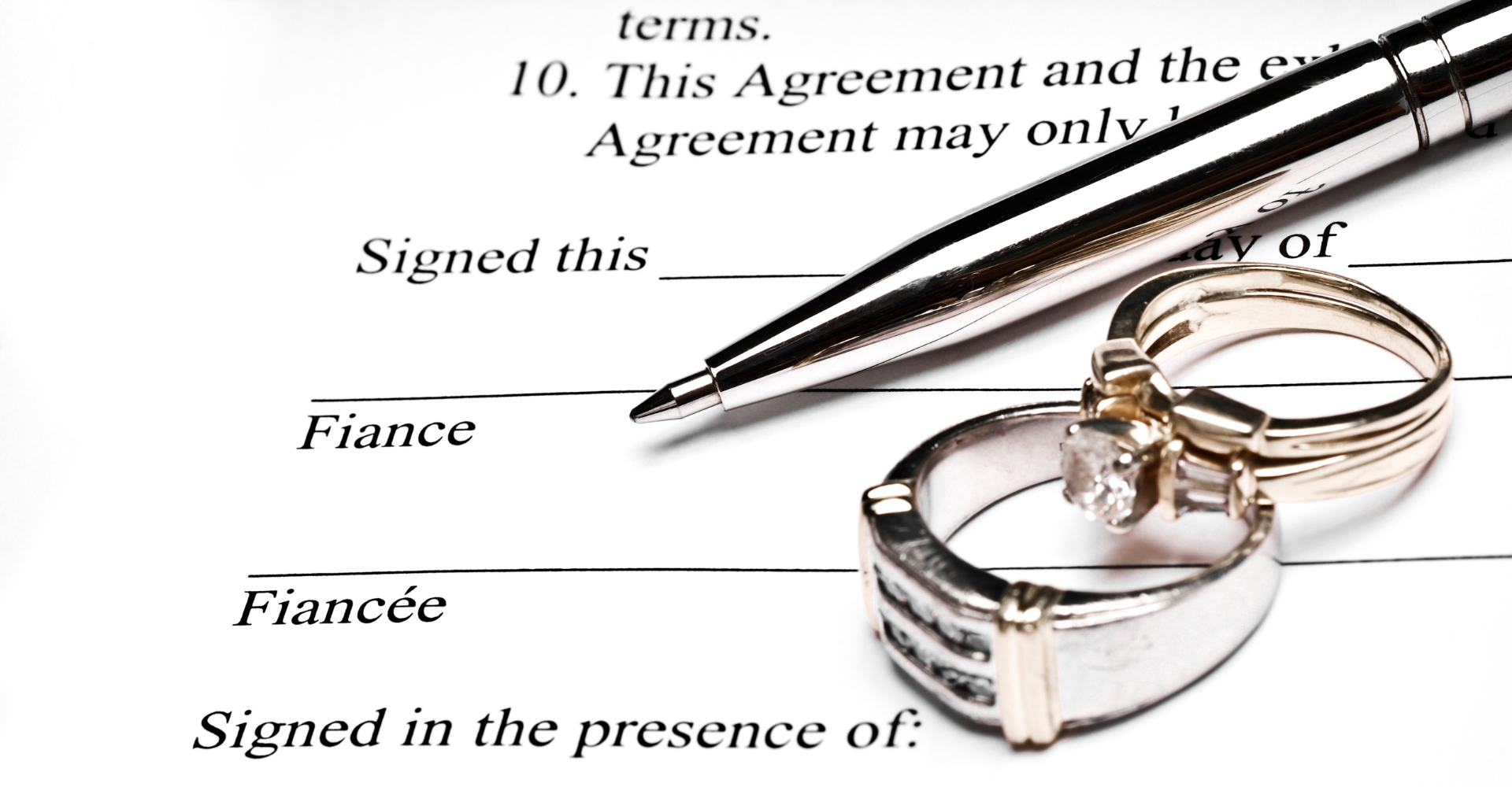 Pen and rings on a prenuptial agreement