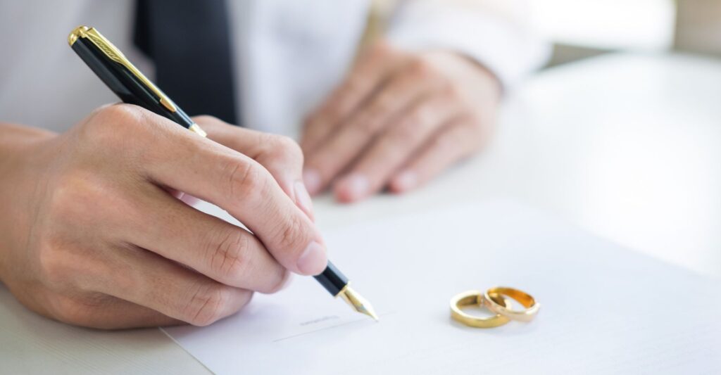 two rings near divorce document being signed