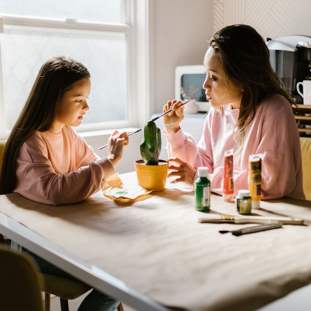 mother painting with her daughter