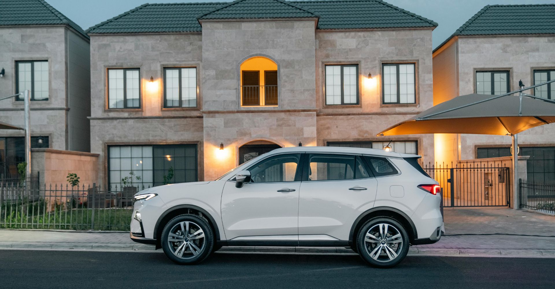 car in front of stone house