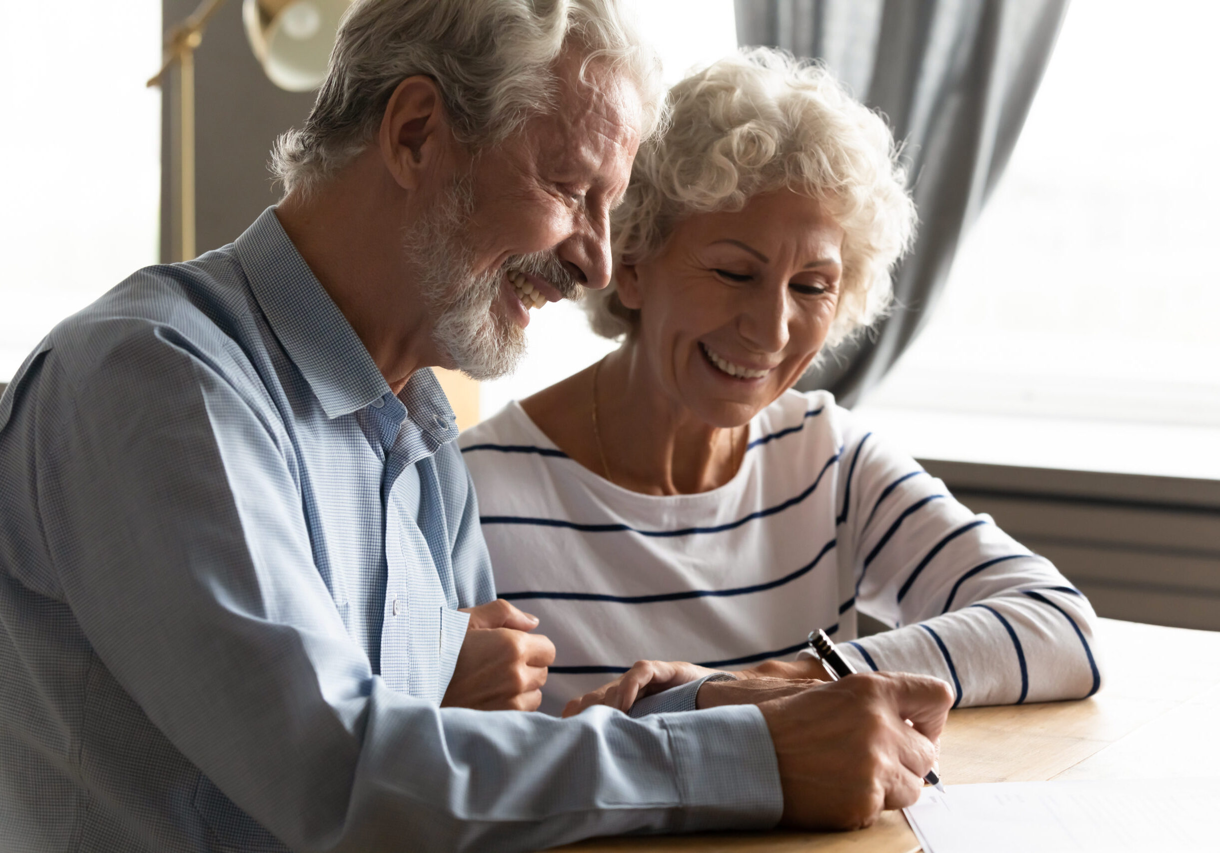 Image of a senior couple reviewing a legal document.